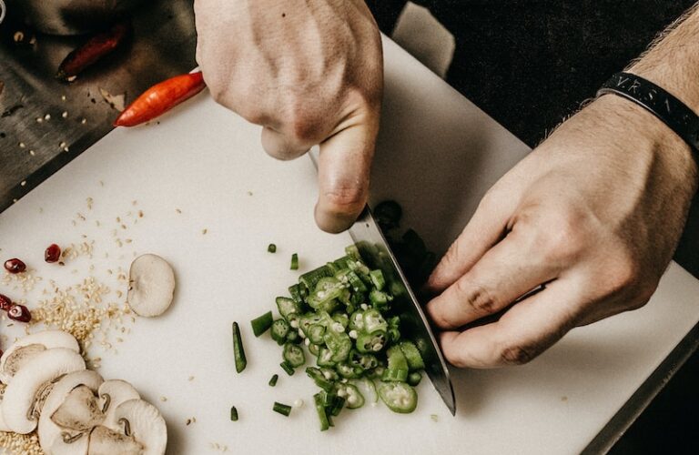 person slicing vegetable